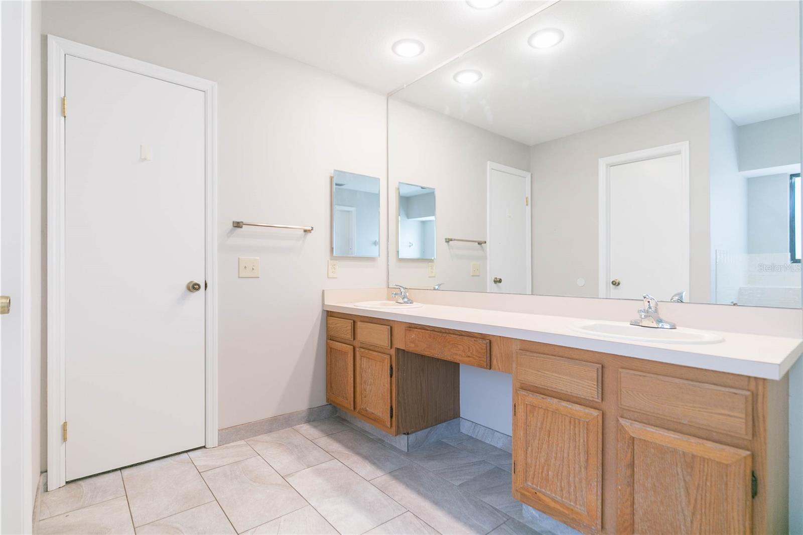 Long countertops and his and her sinks in Primary bath