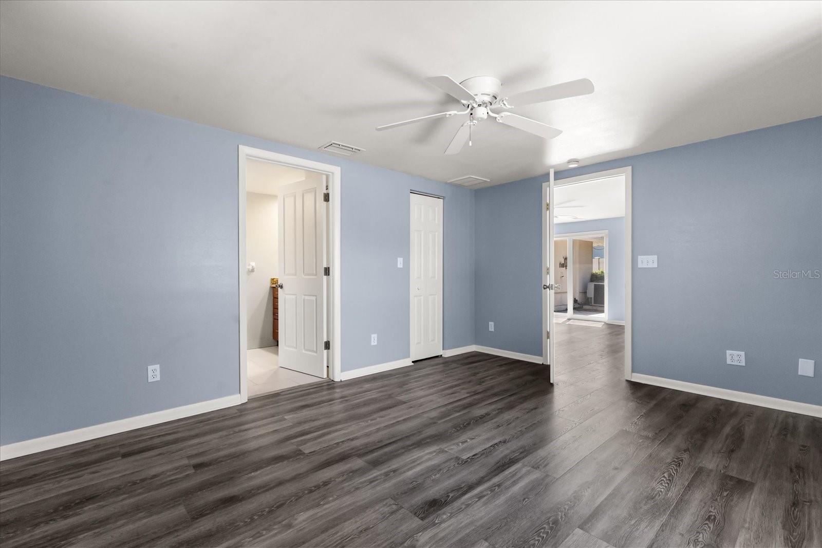 PRIMARY BEDROOM/DOOR TO BATH AND WALK-IN CLOSET AND OUT TO FAMILY ROOM