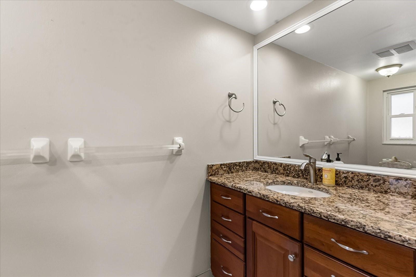 PRIMARY BATH WITH GRANITE COUNTER TOPS AND SOLID WOOD CABINETS