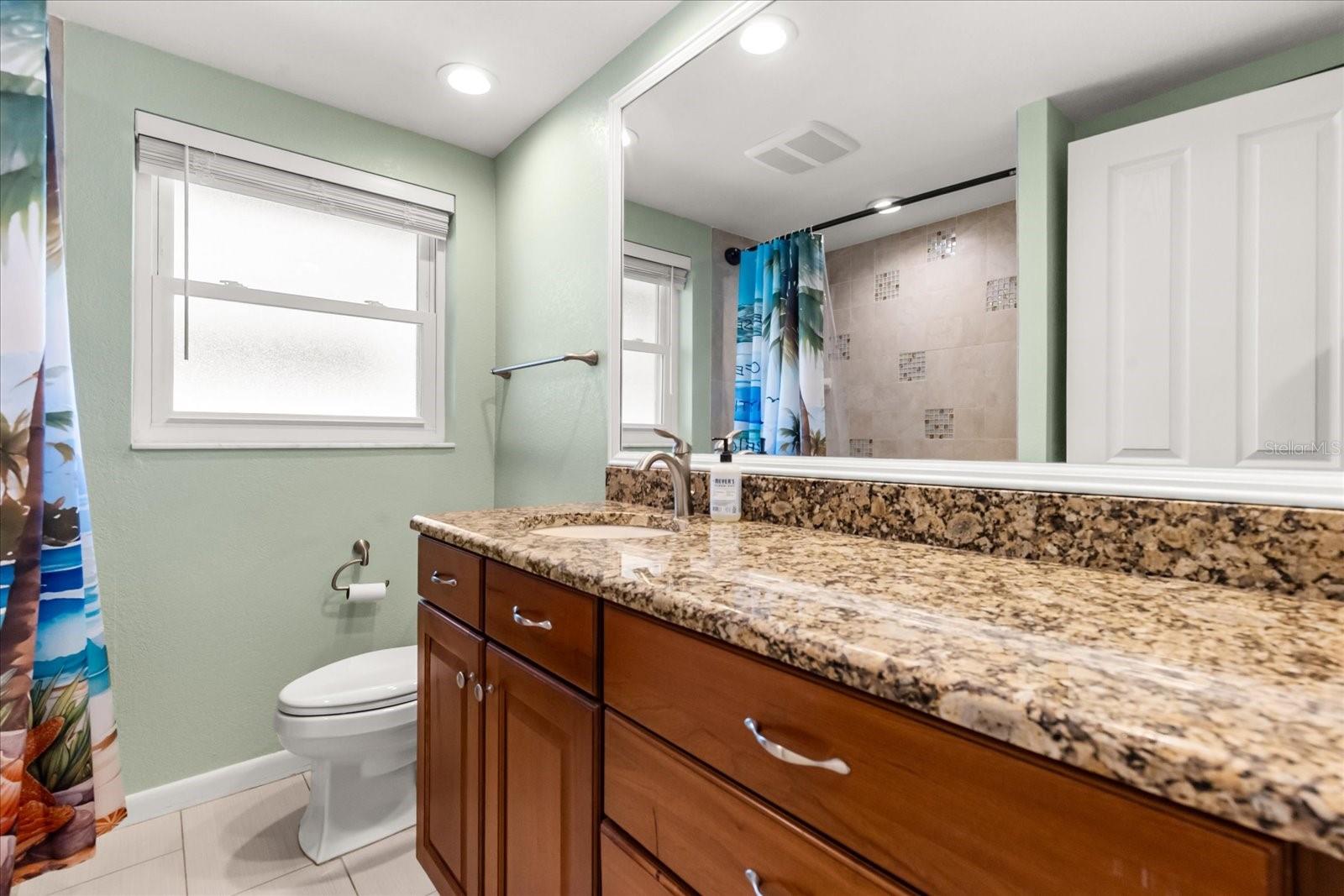 BATH 1/GUEST BATH WITH GRANITE COUNTER TOPS AND SOLID WOOD CABINETS