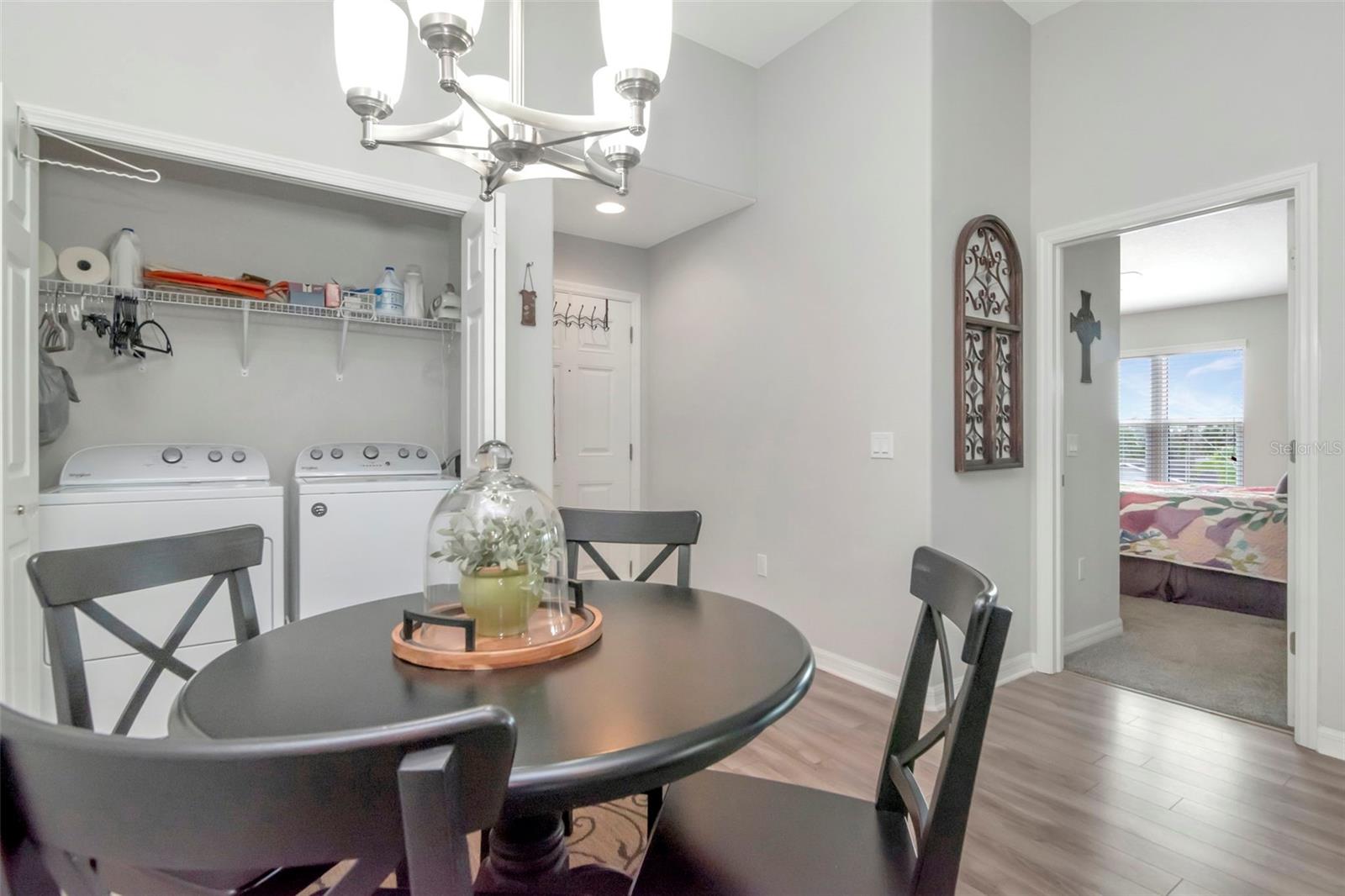 Laundry Closet, dinette and view into Primary Bedroom