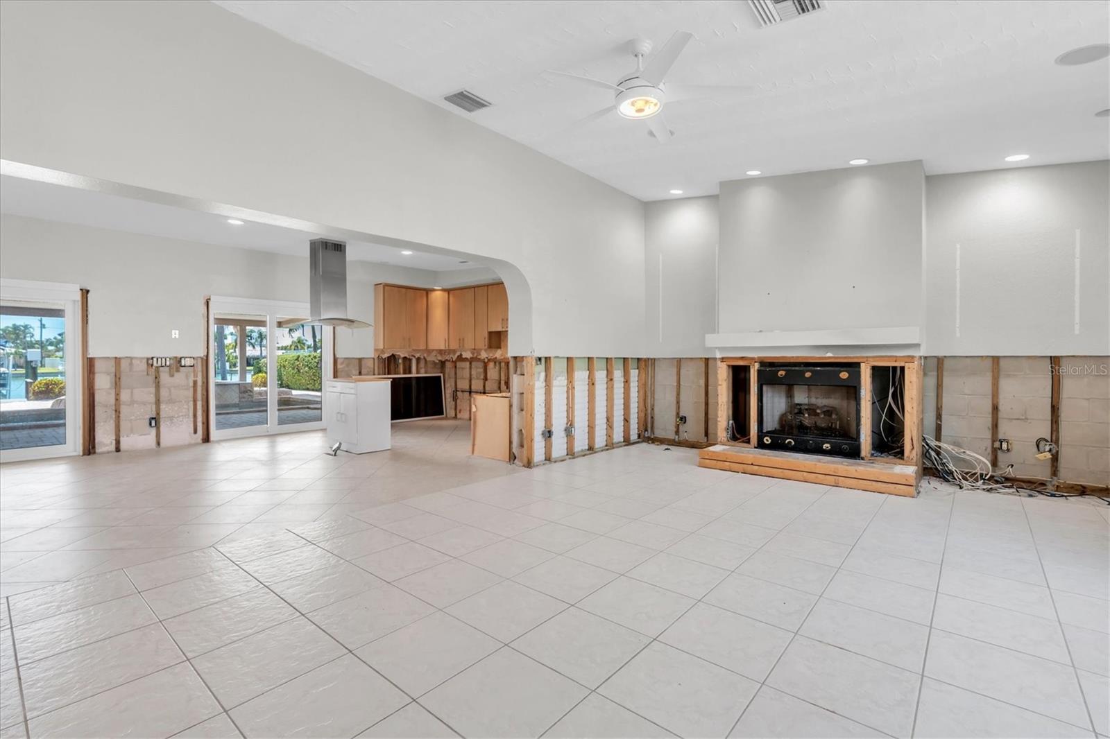 From foyer looking to open living room, fireplace and kitchen
