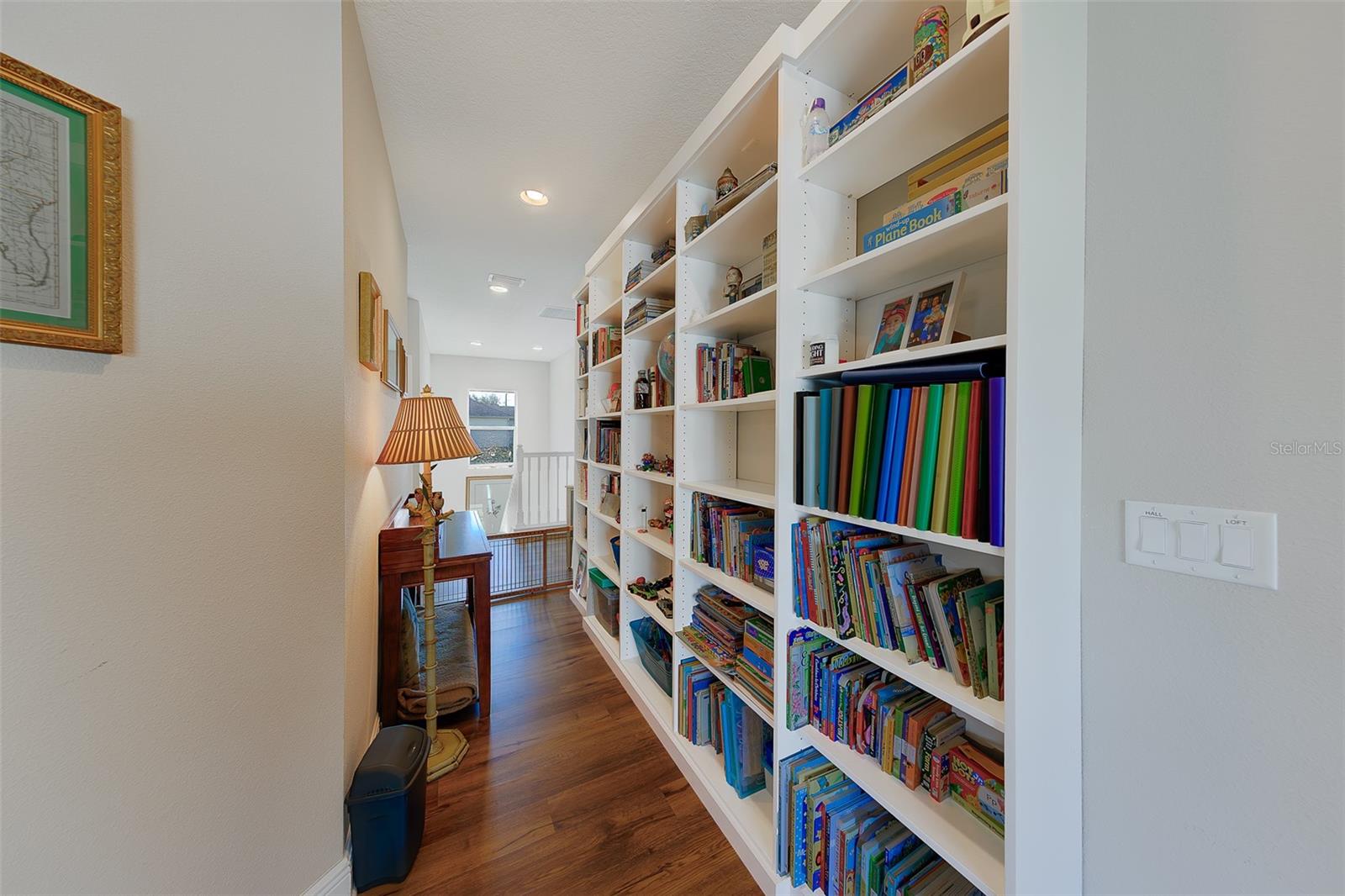 Built in bookshelves and walkway to bonus room