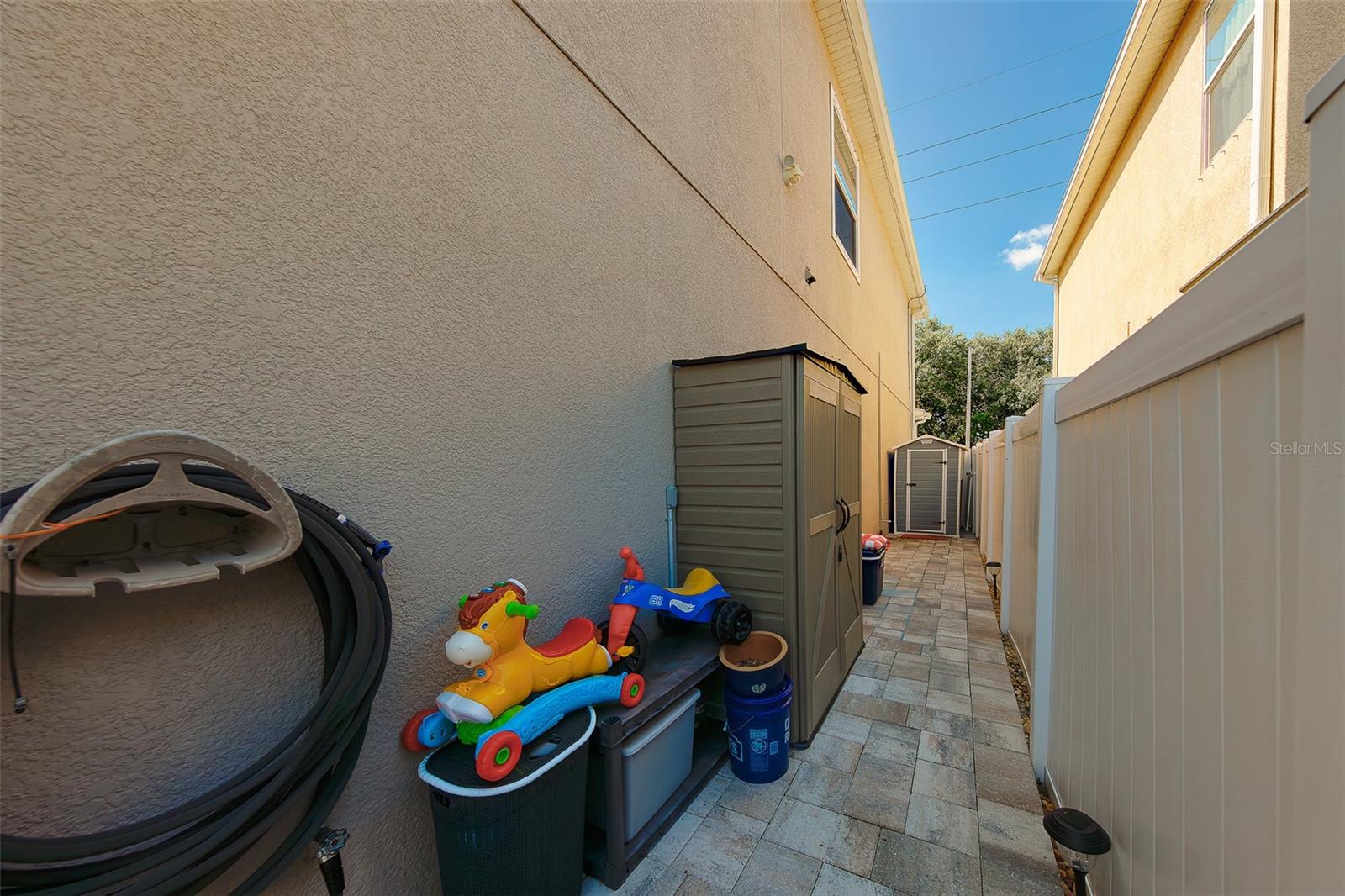 Additional storage on side of house with pavers