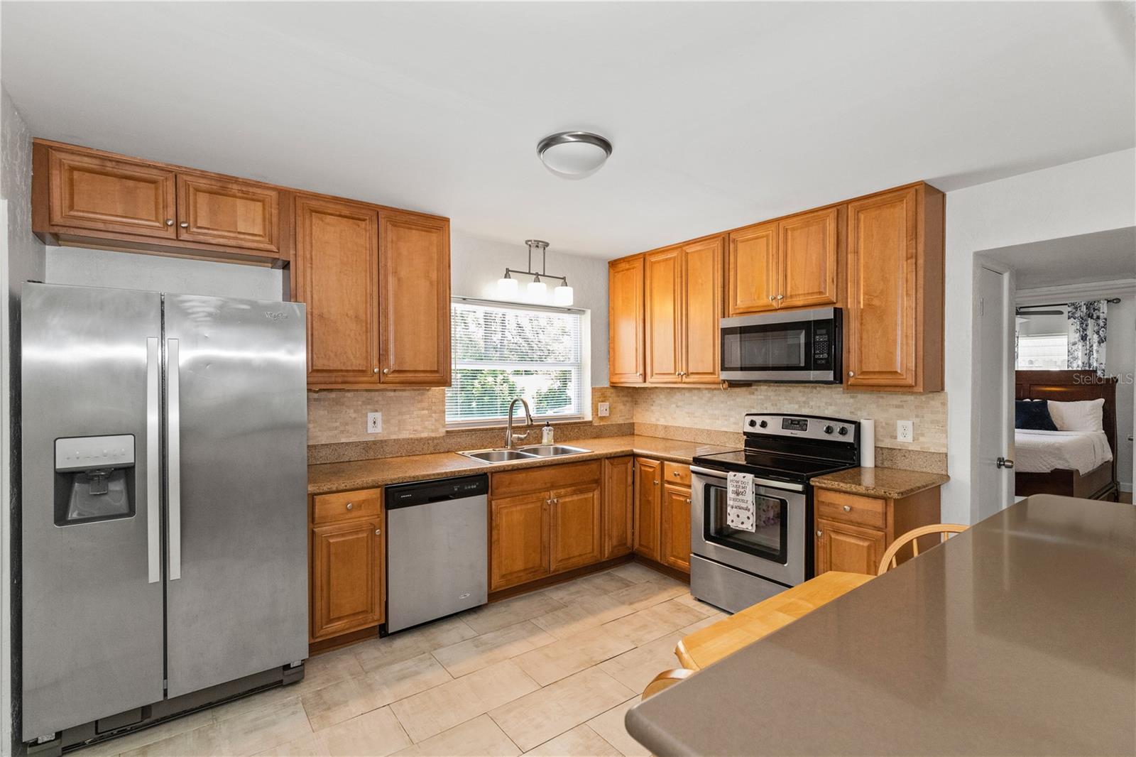 Wide kitchen with stainless steel appliances included