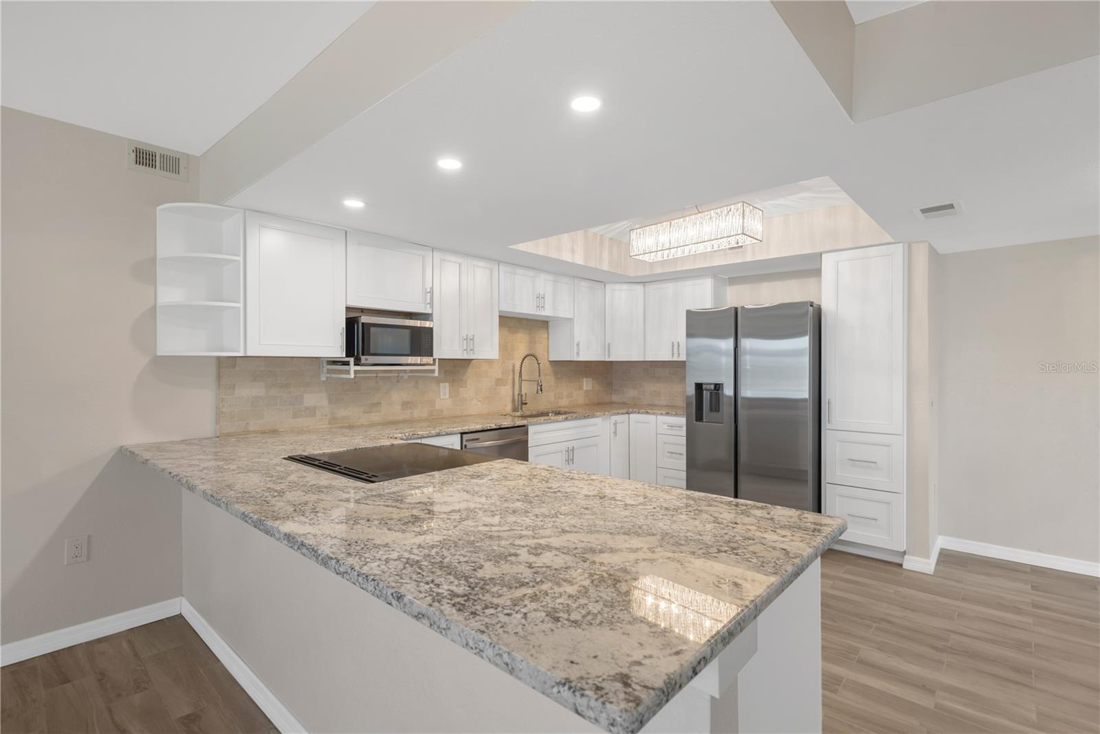 Remodeled kitchen featuring granite counter tops and Kraft Maid cabinetry