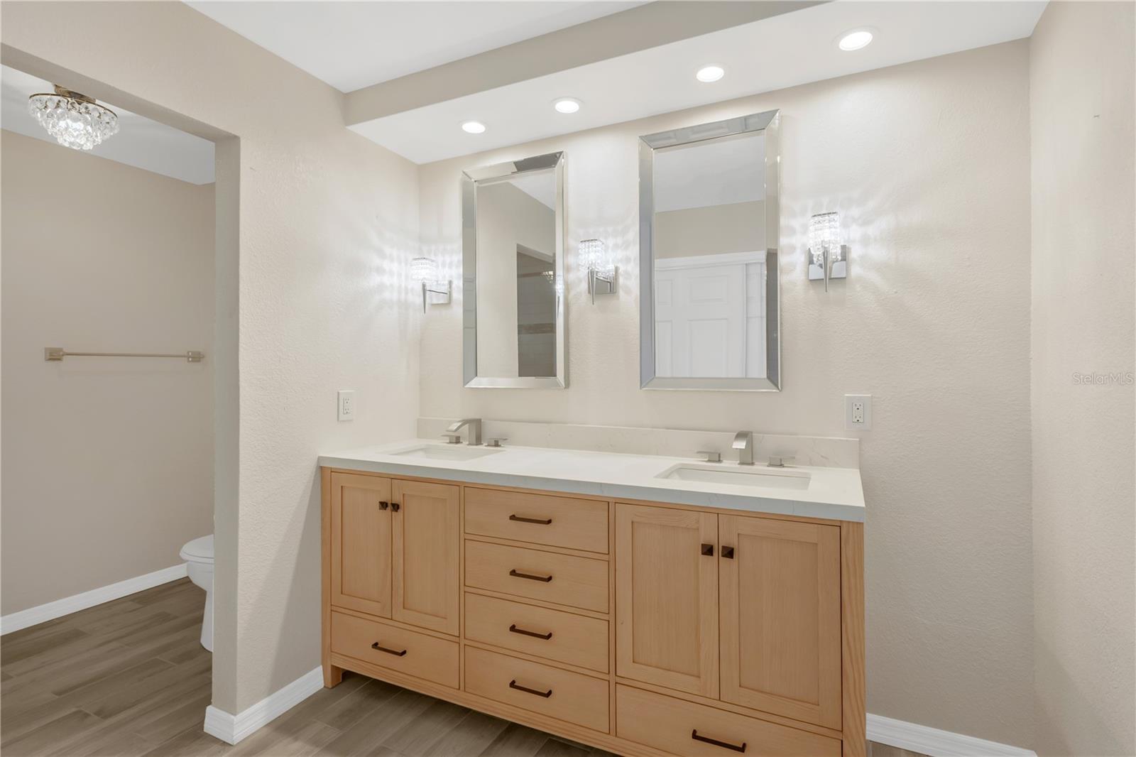 Primary bathroom featuring dual vanities