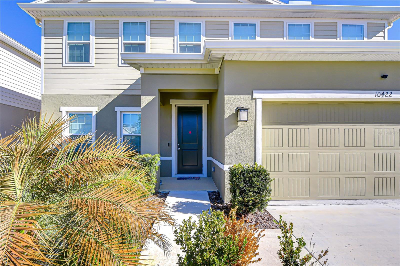 Lush landscaping enhances the home’s inviting front elevation.
