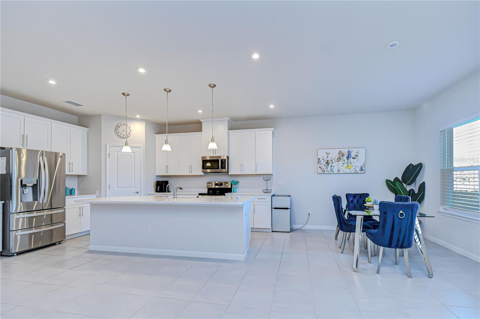 Open kitchen and dining layout ideal for gatherings.