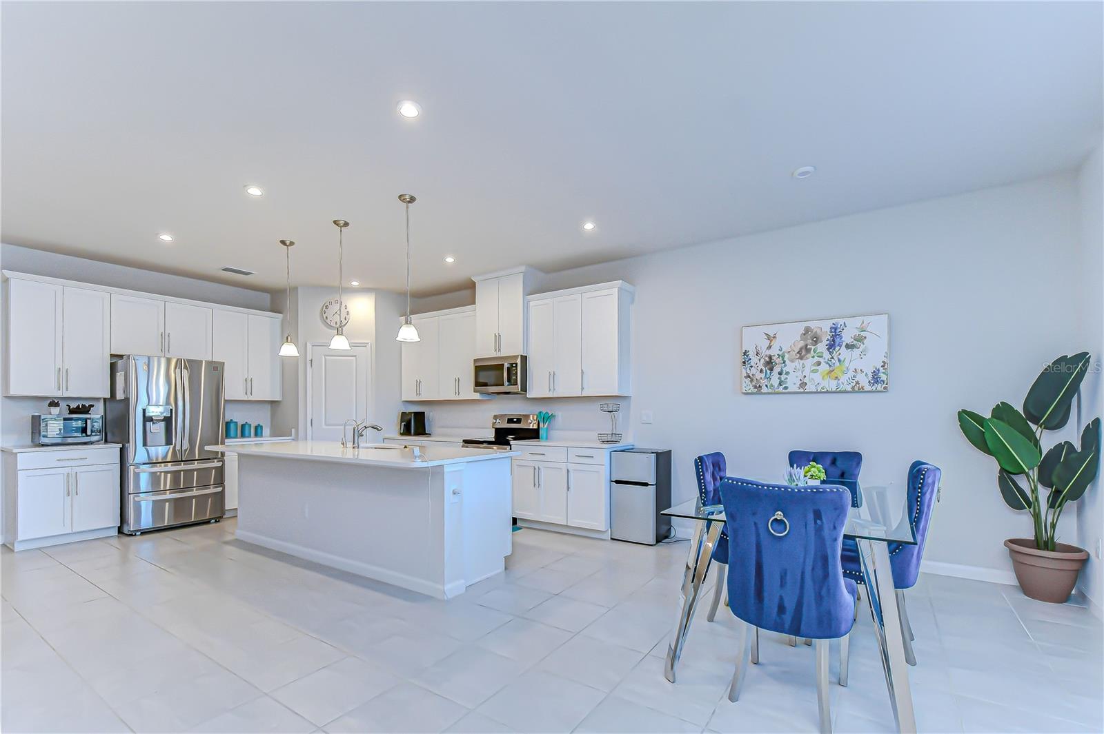 Alternate view highlighting the kitchen’s flow into the dining space.
