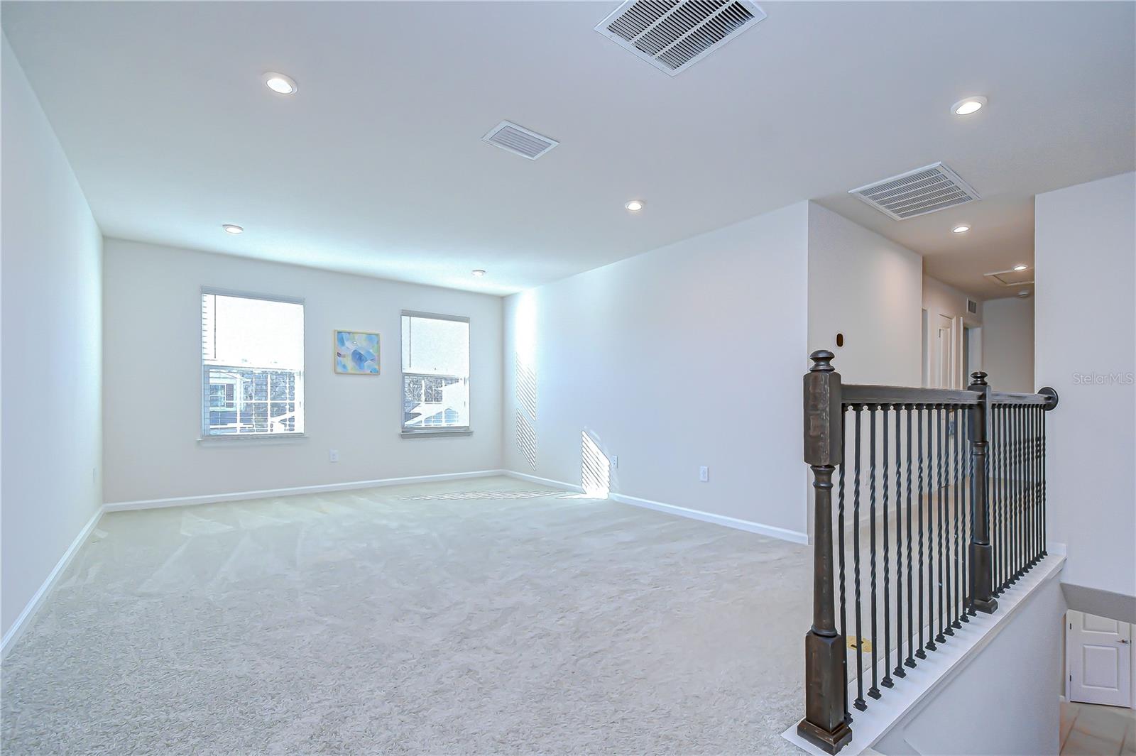 Welcoming upstairs loft—ideal for relaxation or a media space