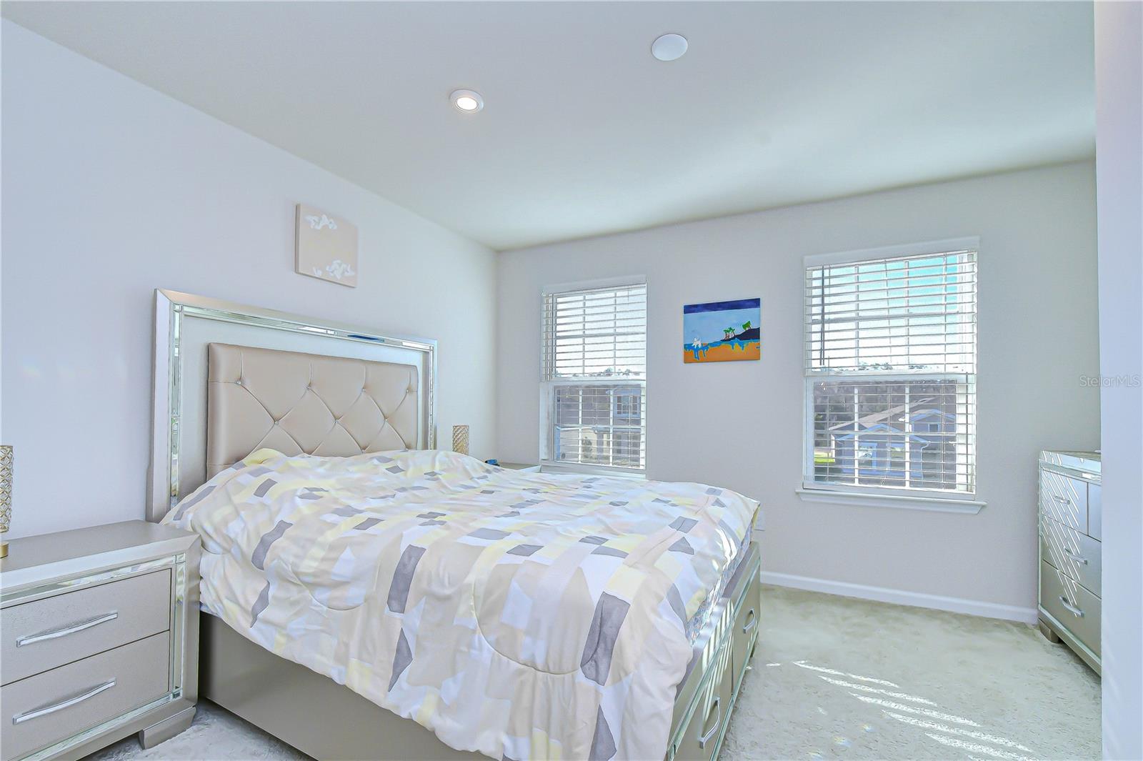 Inviting bedroom with large windows and abundant light.