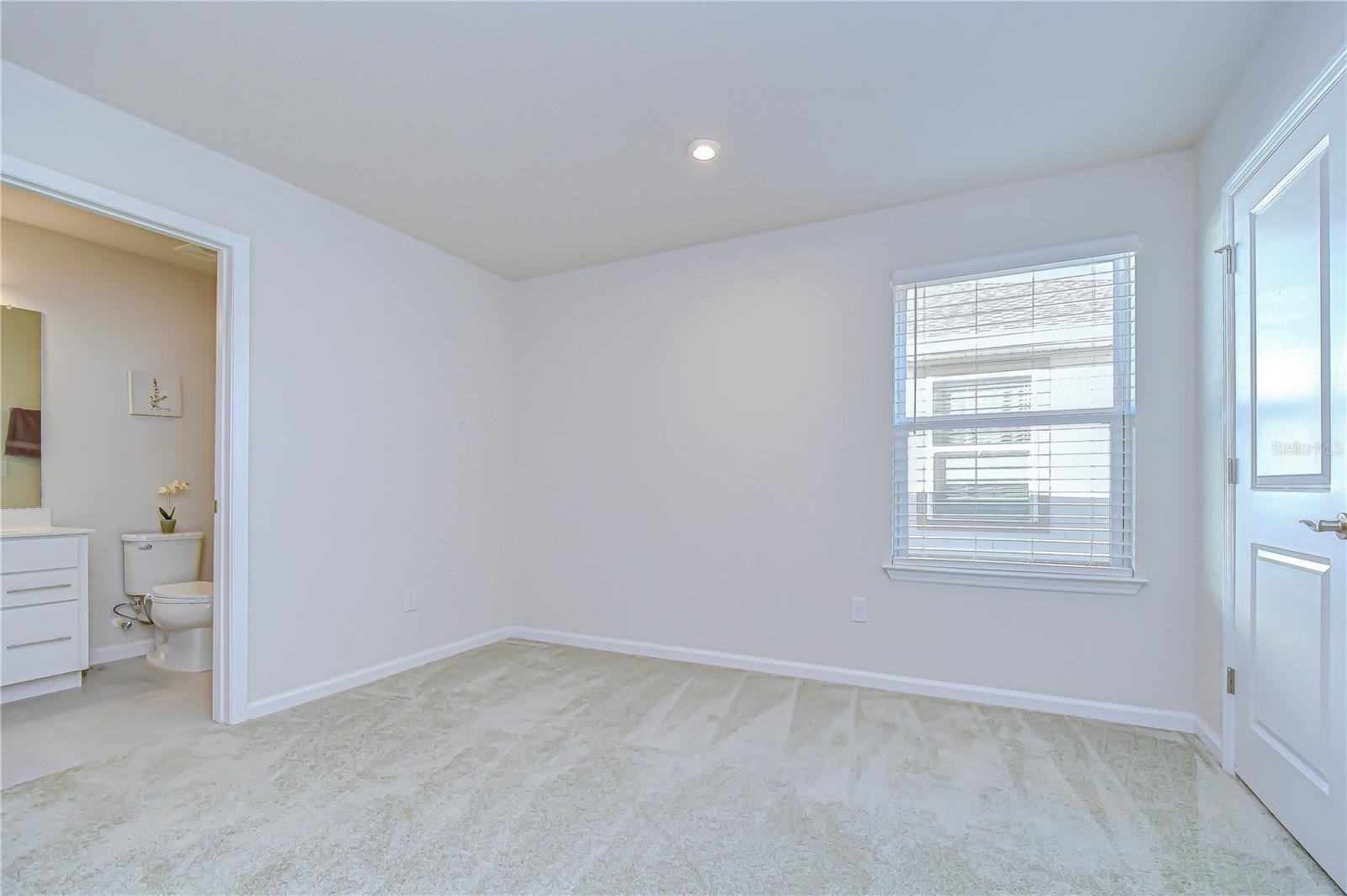 Bedroom with convenient access to the adjacent bathroom.