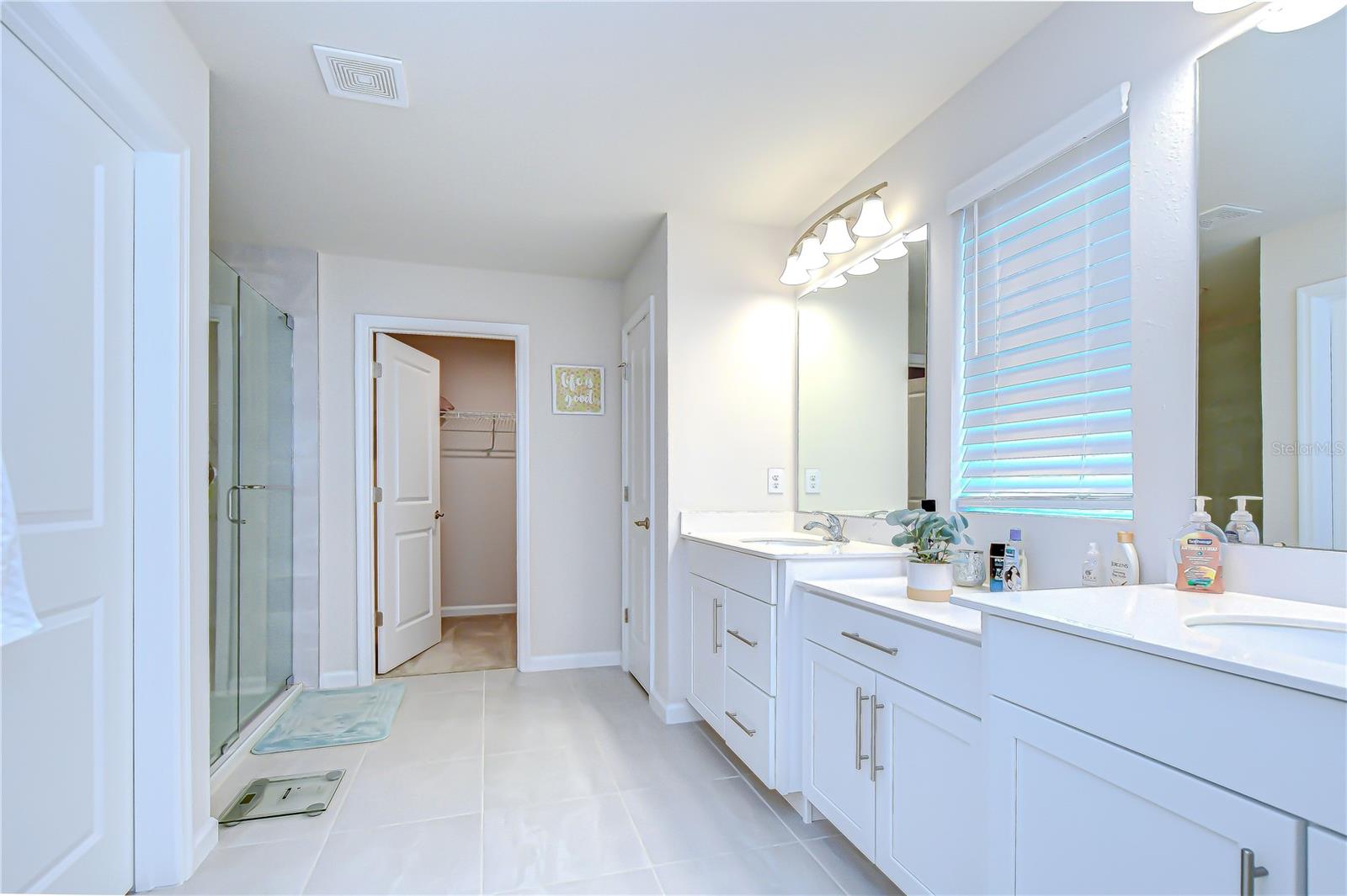 Spa-inspired primary bathroom with generous storage.