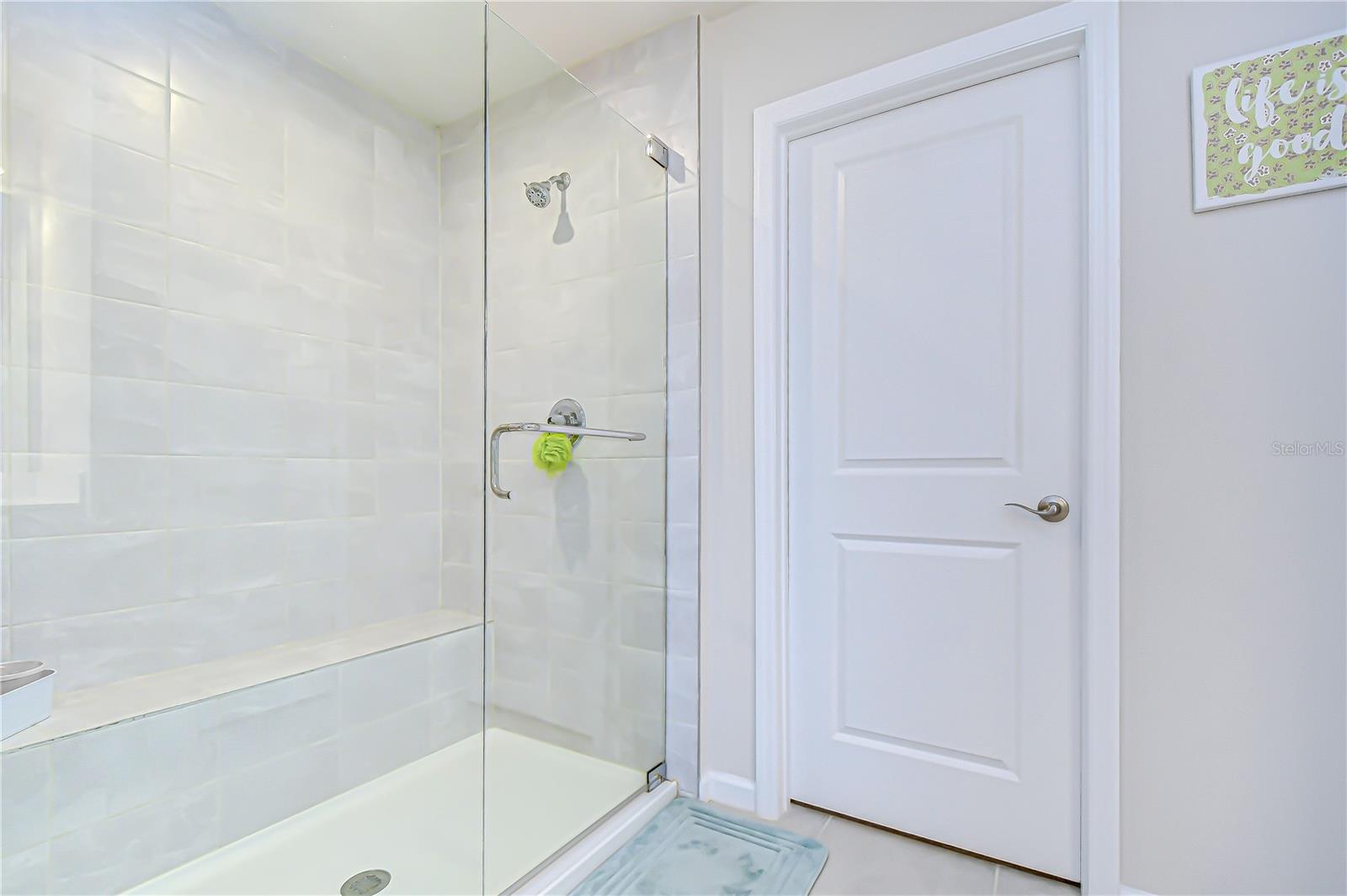 Elegant primary bath showcasing a glass-enclosed shower.