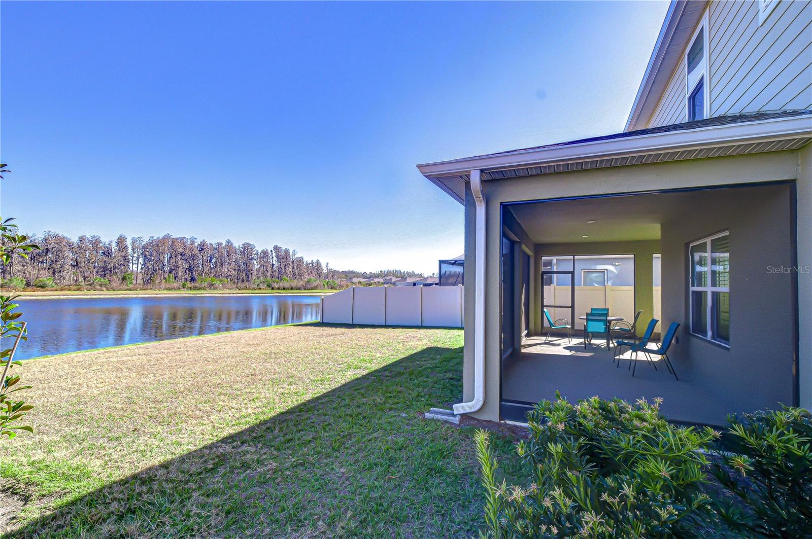 Rear exterior showcasing lanai and serene pond.