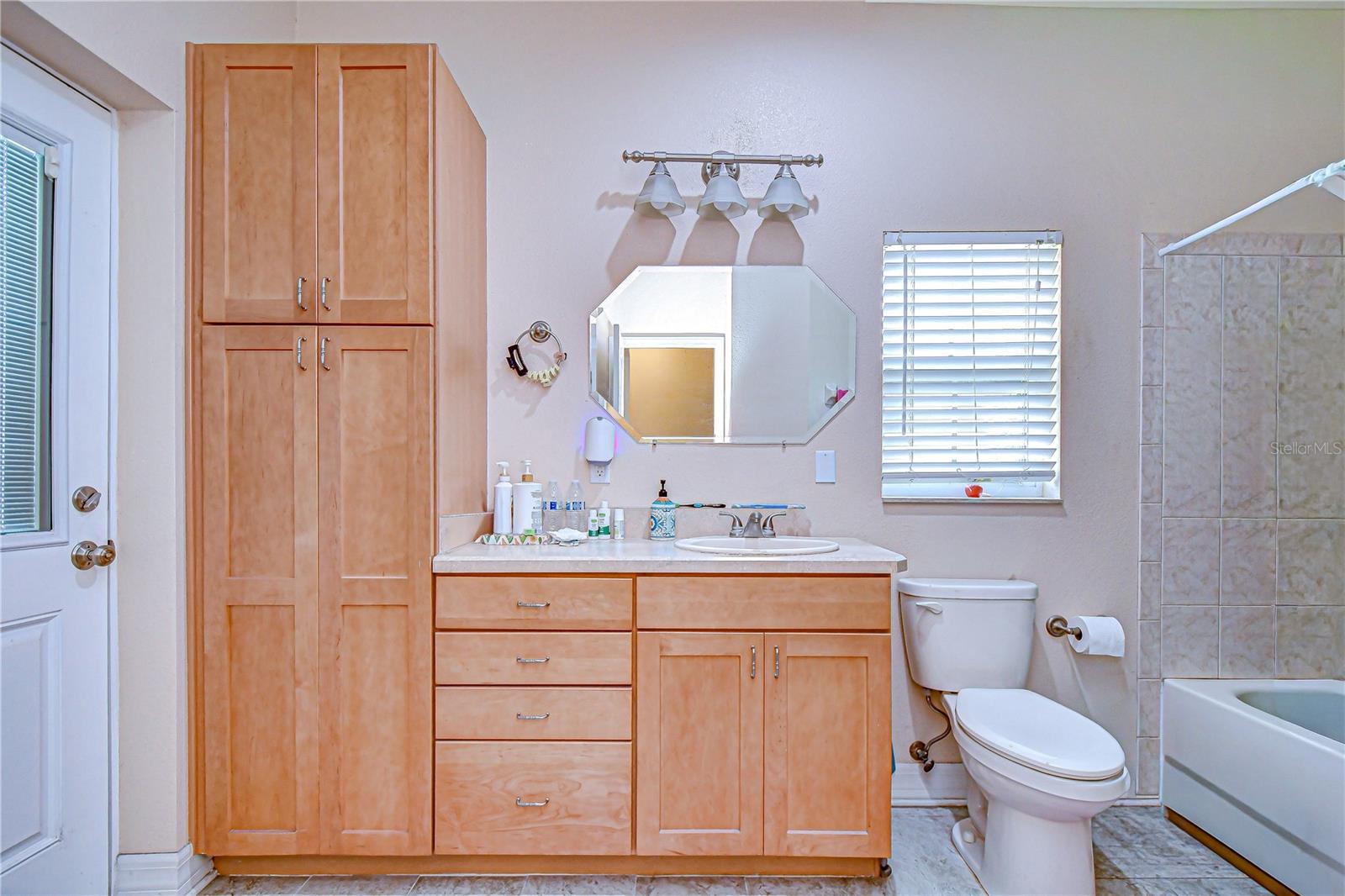 Guest bath with built-in storage & lanai access