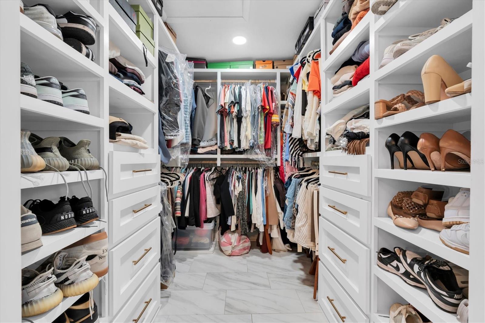 Primary Suite closet designed by California Closets