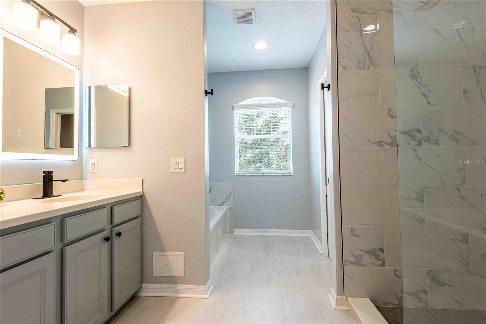 Water closet next to the shower stall.