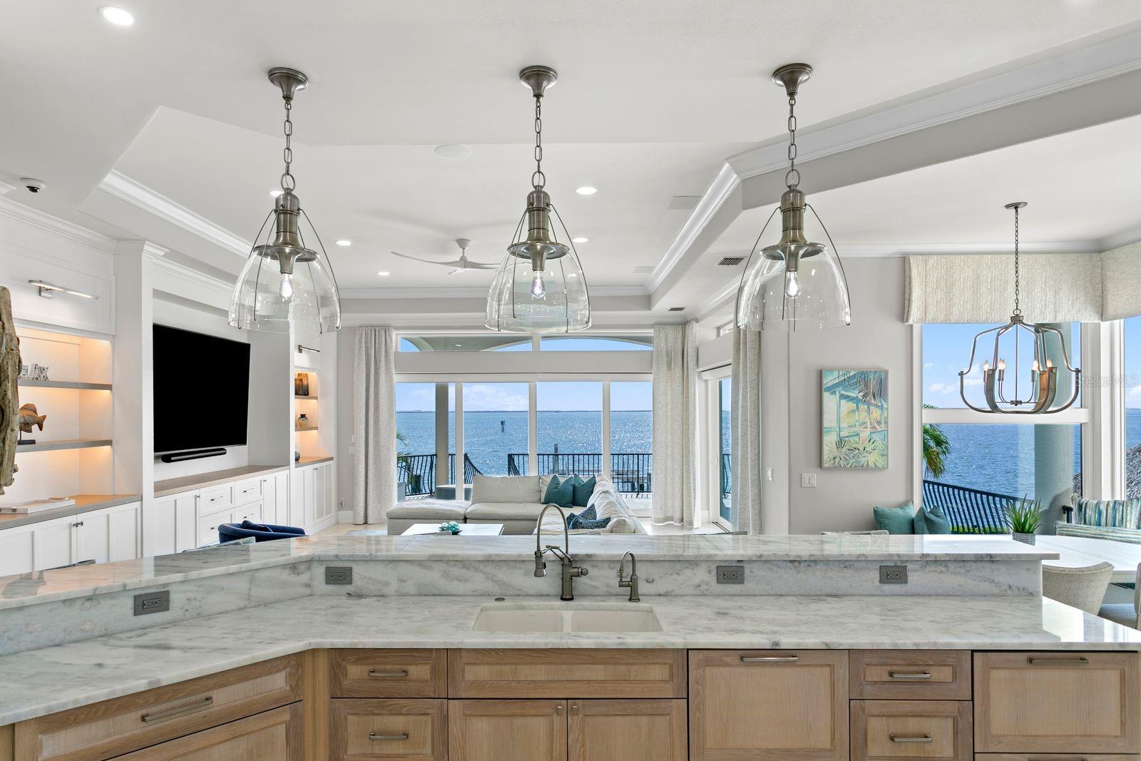 Another breathtaking kitchen view overlooking the stunning waterfront landscape.