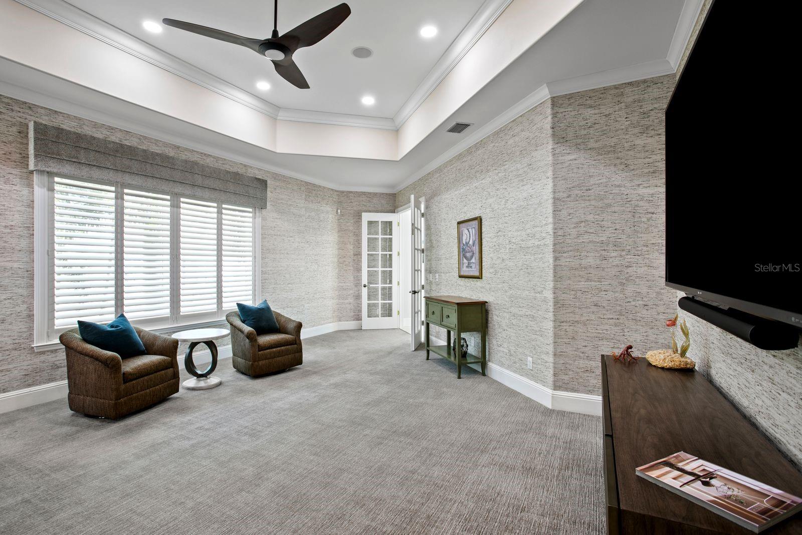 A sophisticated social lounge complete with a built in bar and media area.