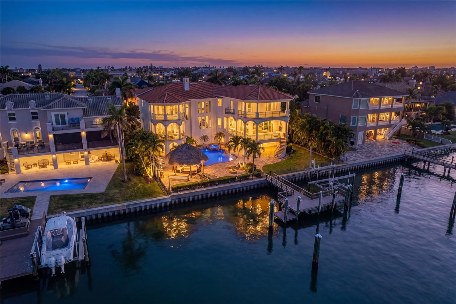 Stunning twilight view of the rear elevation of this exceptional Tierra Verde residence.