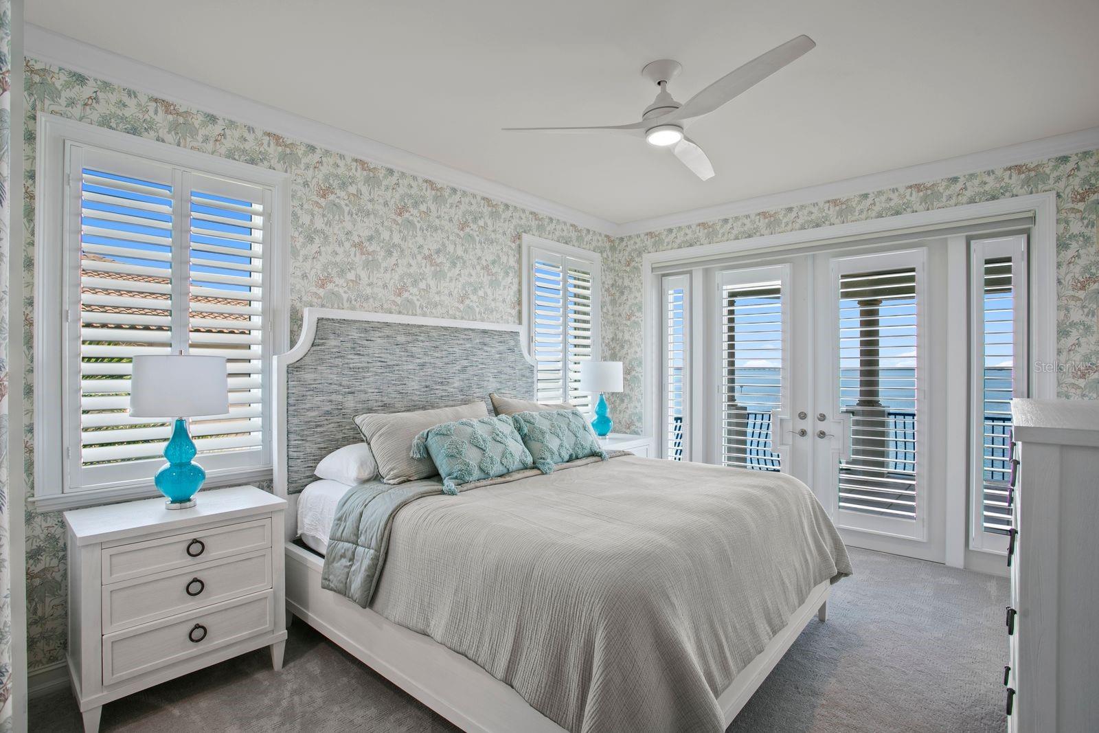 Top-leel bedroom two with French doors opening onto a private balcony.