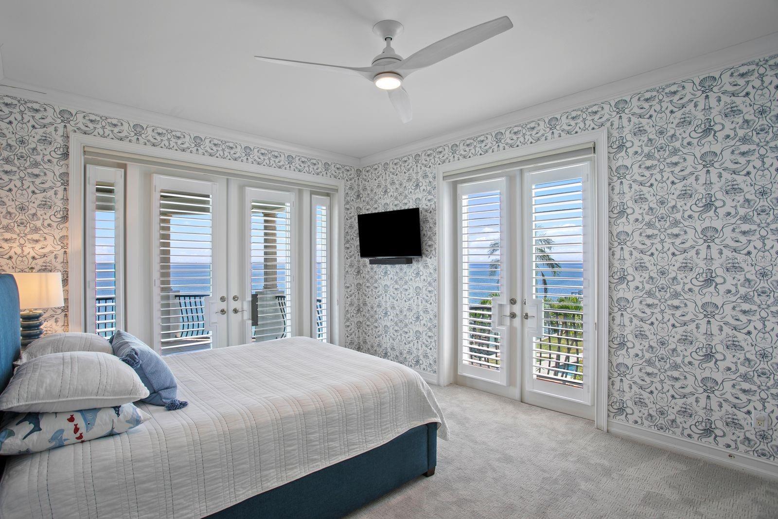 Top level, bedroom three with French doors opening to a breathtaking balcony with ocean views.