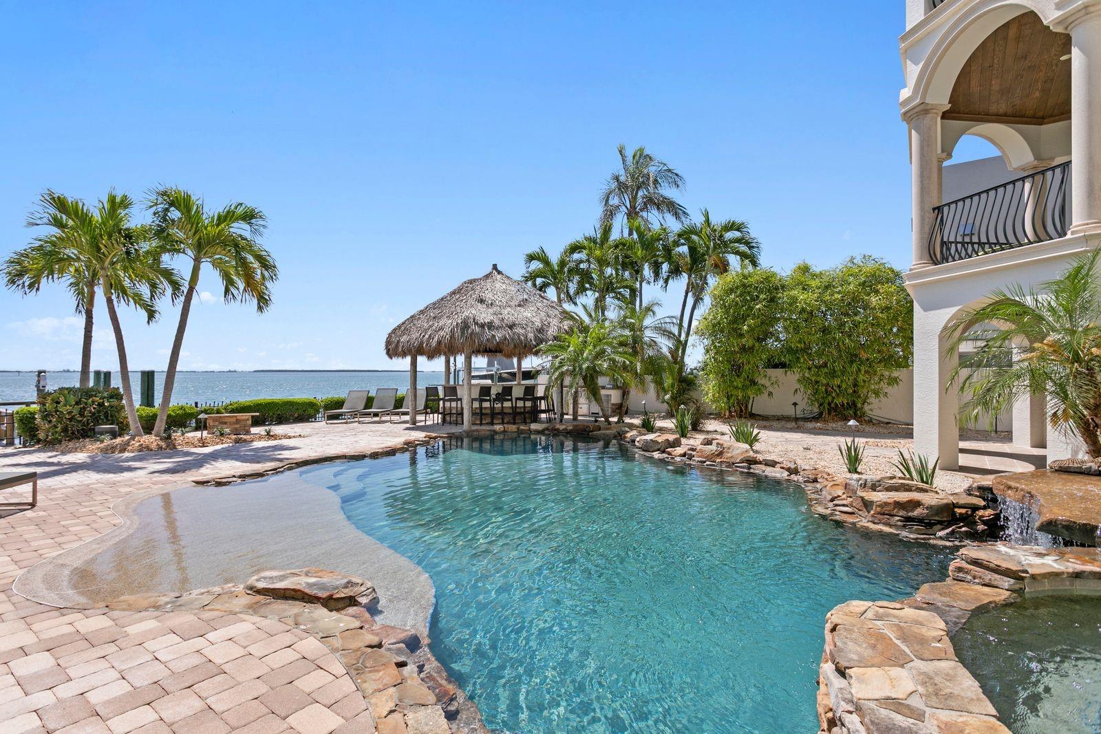 Lagoon style pool with spa and waterfall.