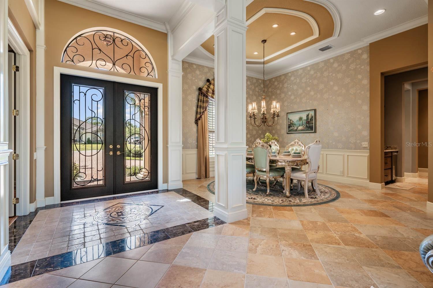 Dramatic entry with tile accent inlay in foyer & architectual details