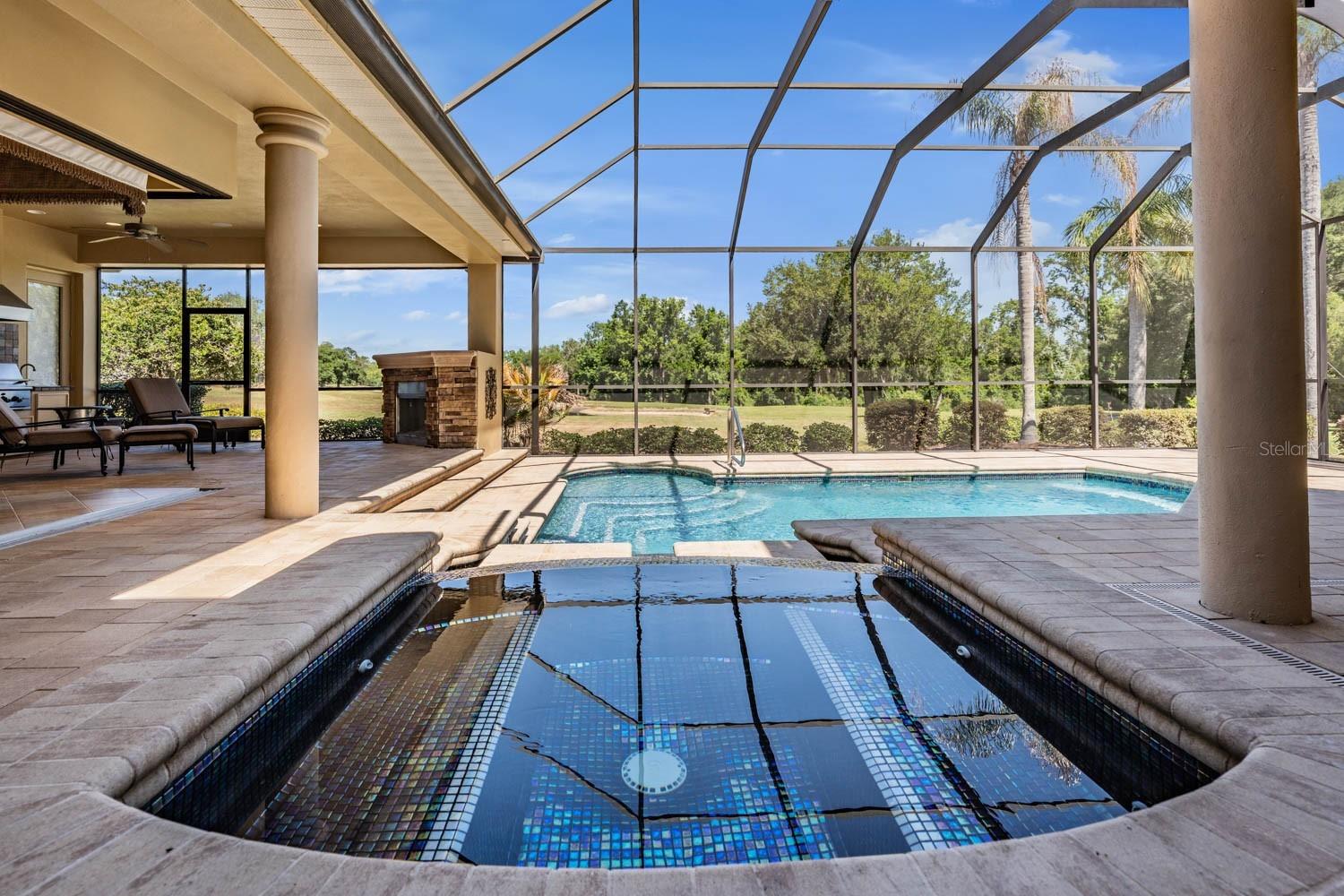 Glass Spill over Spa into Iconic Glass pool overlooking serene golf course and pond!