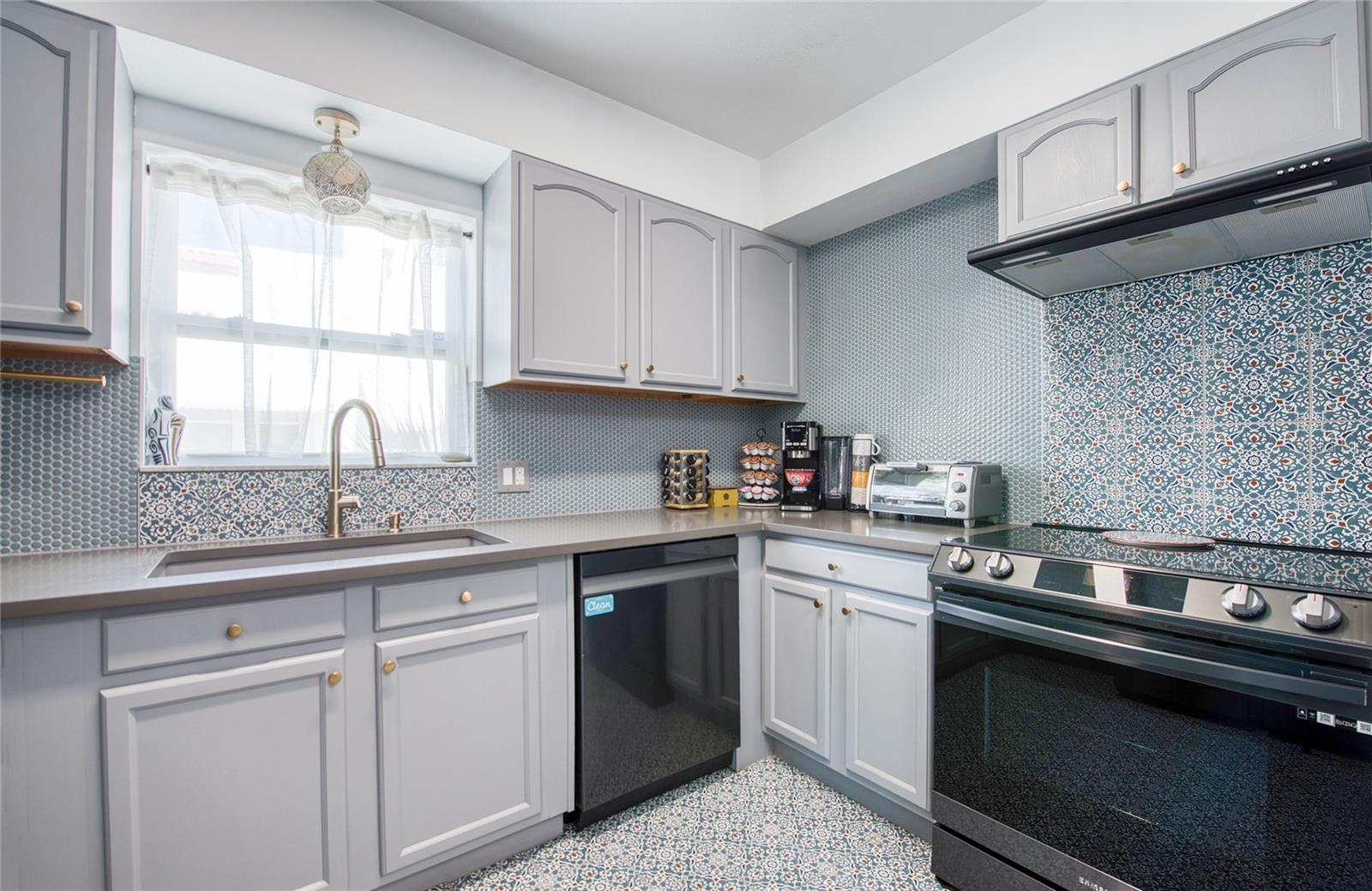 CASA BAJA: Kitchen with pattern tile flooring & penny backsplash tilinh