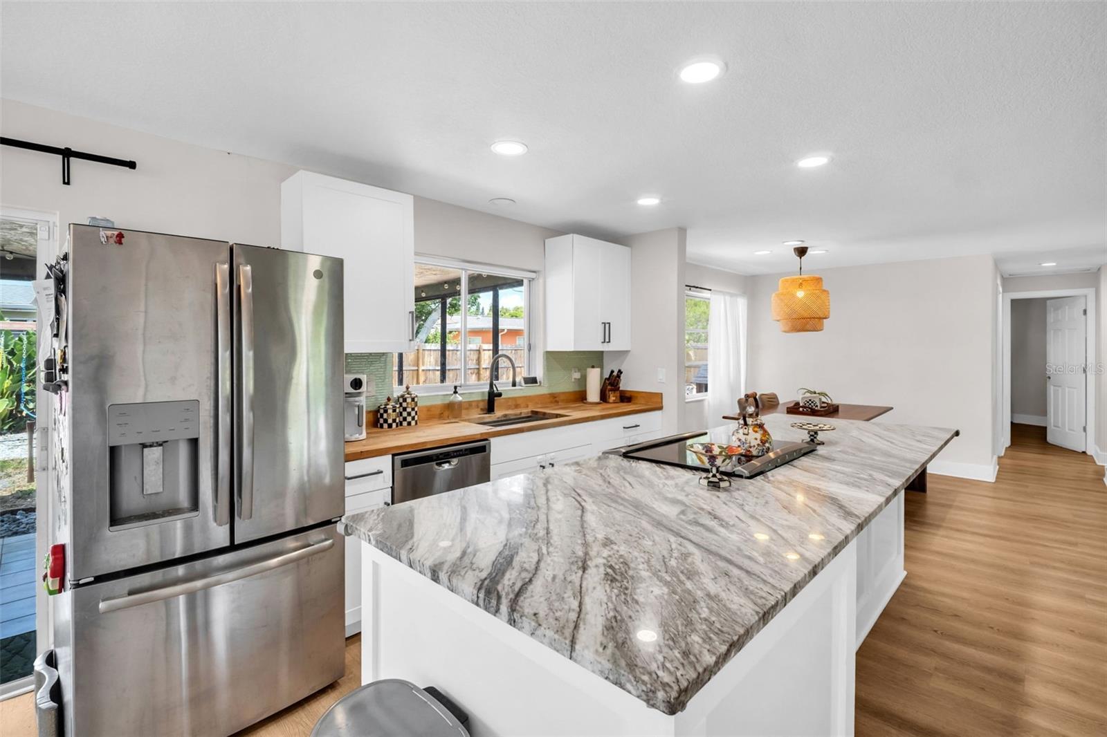Beautiful accept butcher block countertops and kitchen window overlooking the backyard~