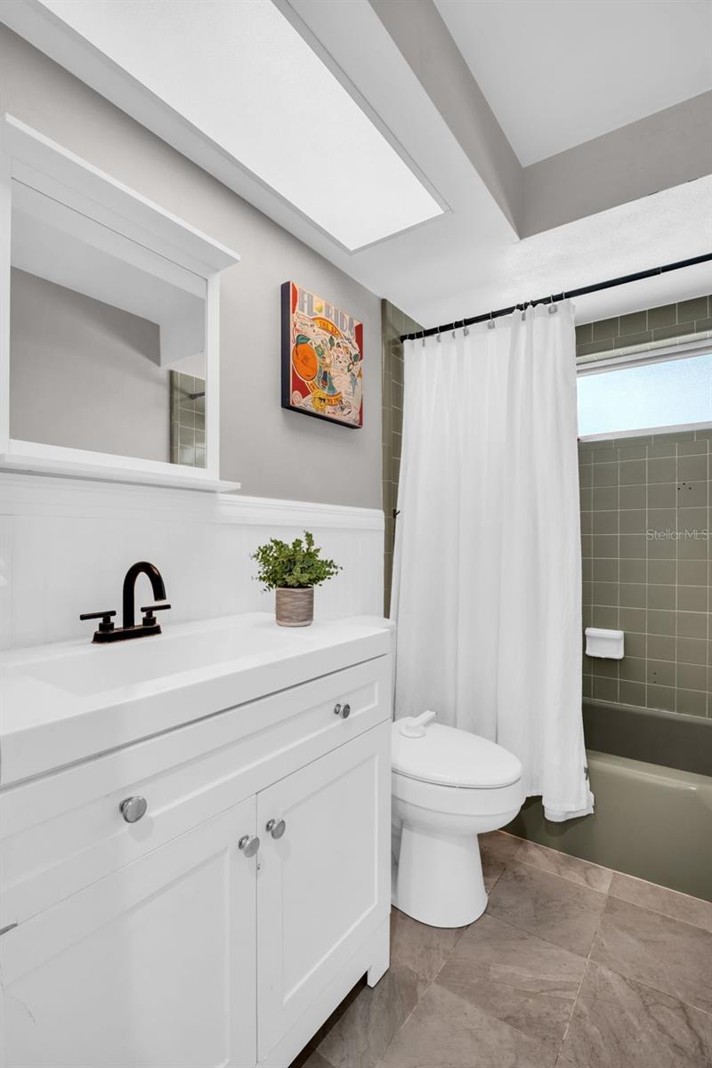 Beautiful hall bath with an updated vanity & a convenient tub/shower combo~