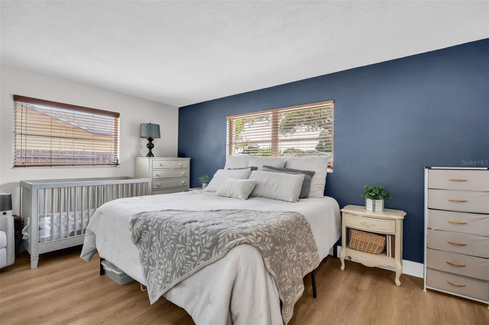Oversized primary retreat big enough for a king, multiple furniture pieces, and still additional space to spare~