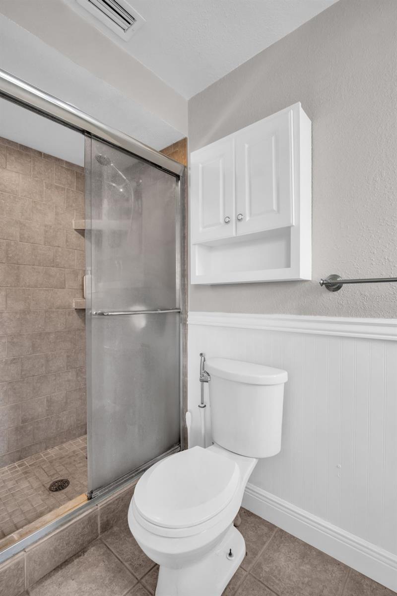 Glass enclosed walk-in shower & chair rail accents~