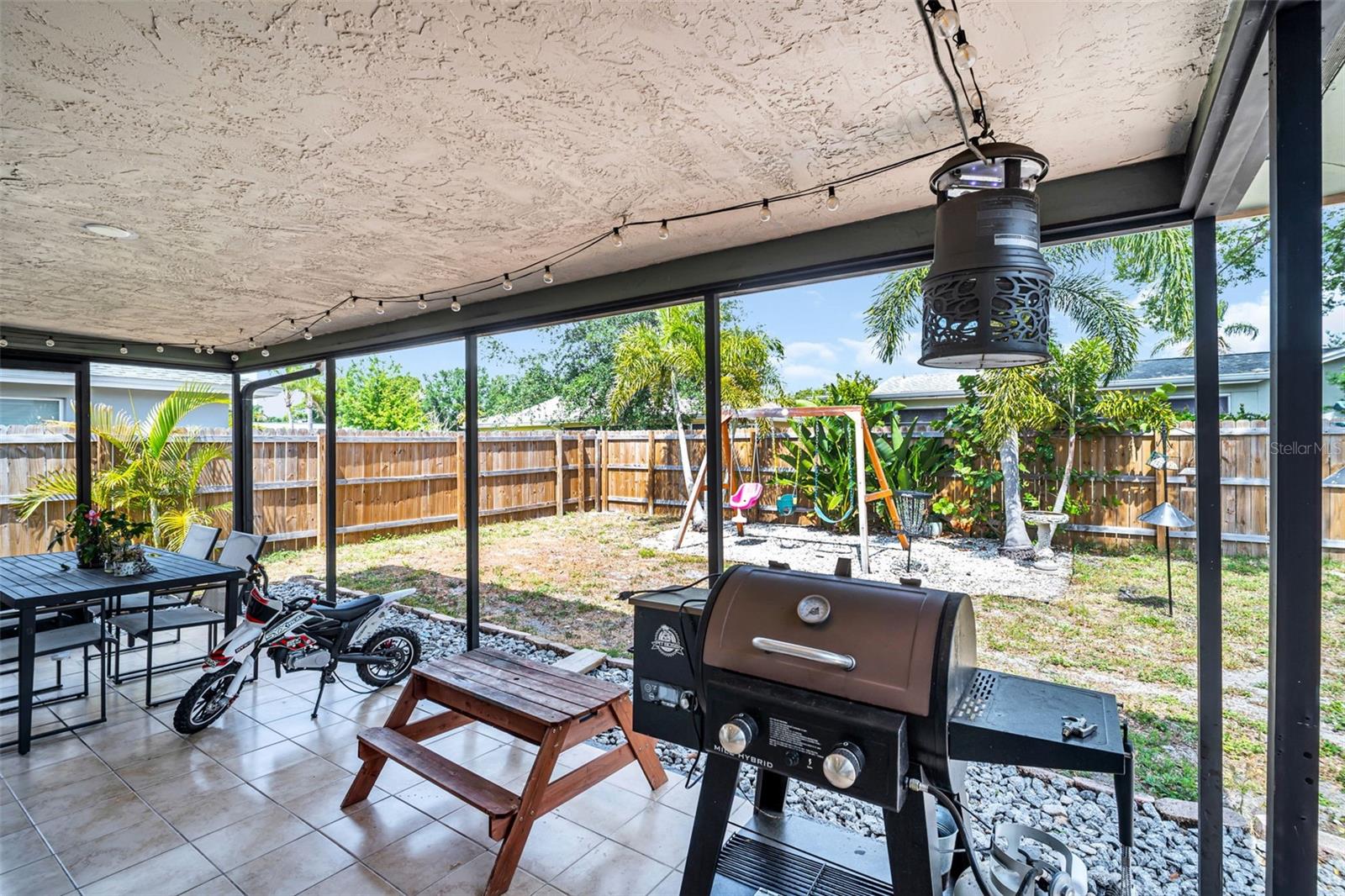Covered back patio overlooking the large backyard for year-round enjoyment~