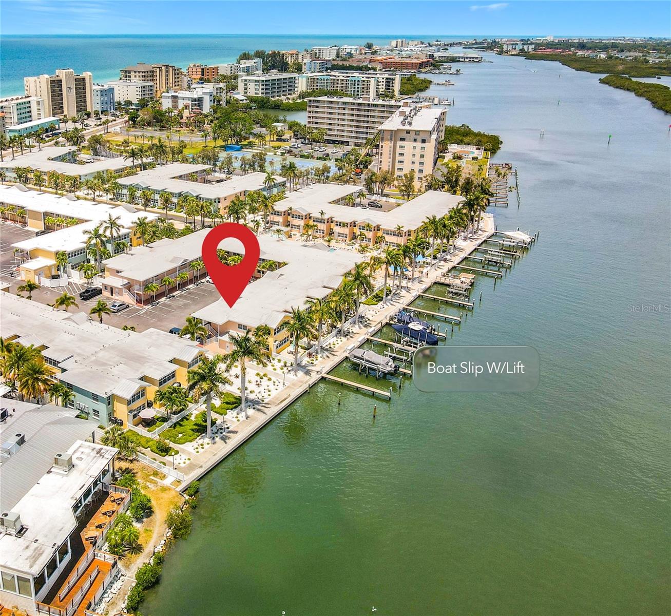 This aerial view shows the unit location and the boat slip with lift location that conveys with this unit.