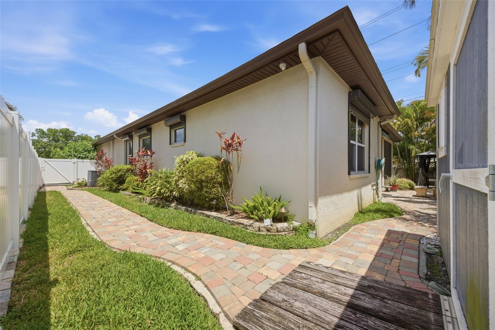 Side view of yard with pavered walkways