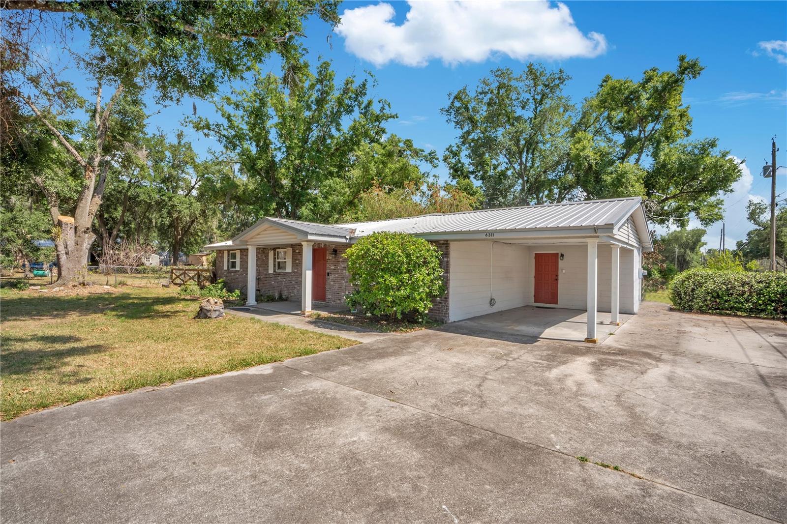 Front, side view showing carport.