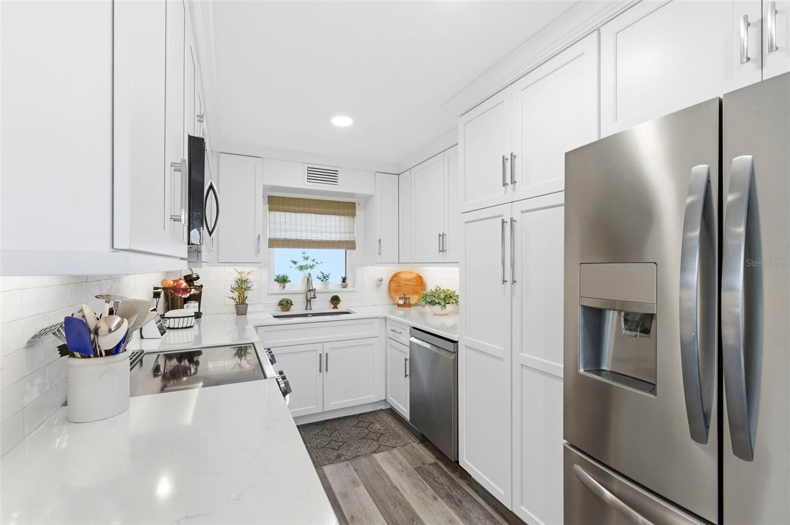 kitchen with quartz counters, stainless steel appliances and pantry
