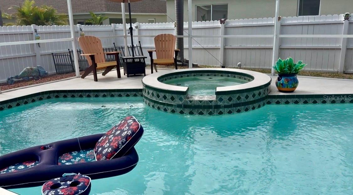 This screened pool screams decadence! Oversized deck for loads of seating, hot tub to relax all those sore muscles.