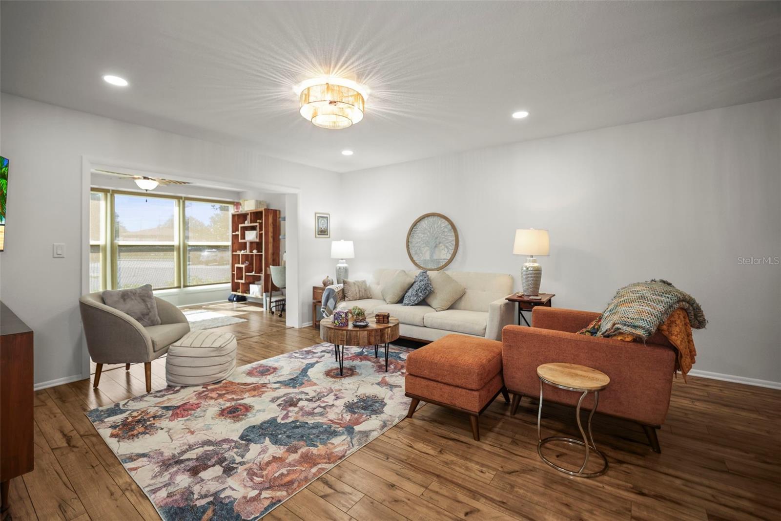 Living room with view to bright and sunny Lanai. Notice the engineered hardwood flooring