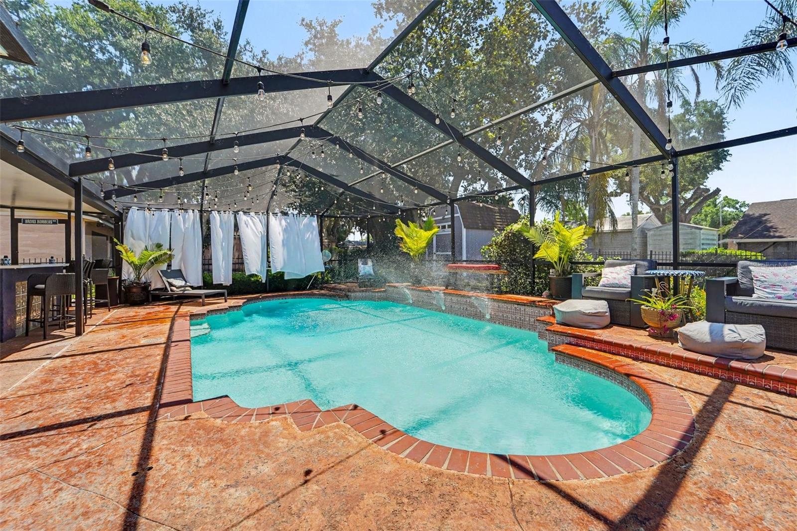 Pool with fountains, privacy shades