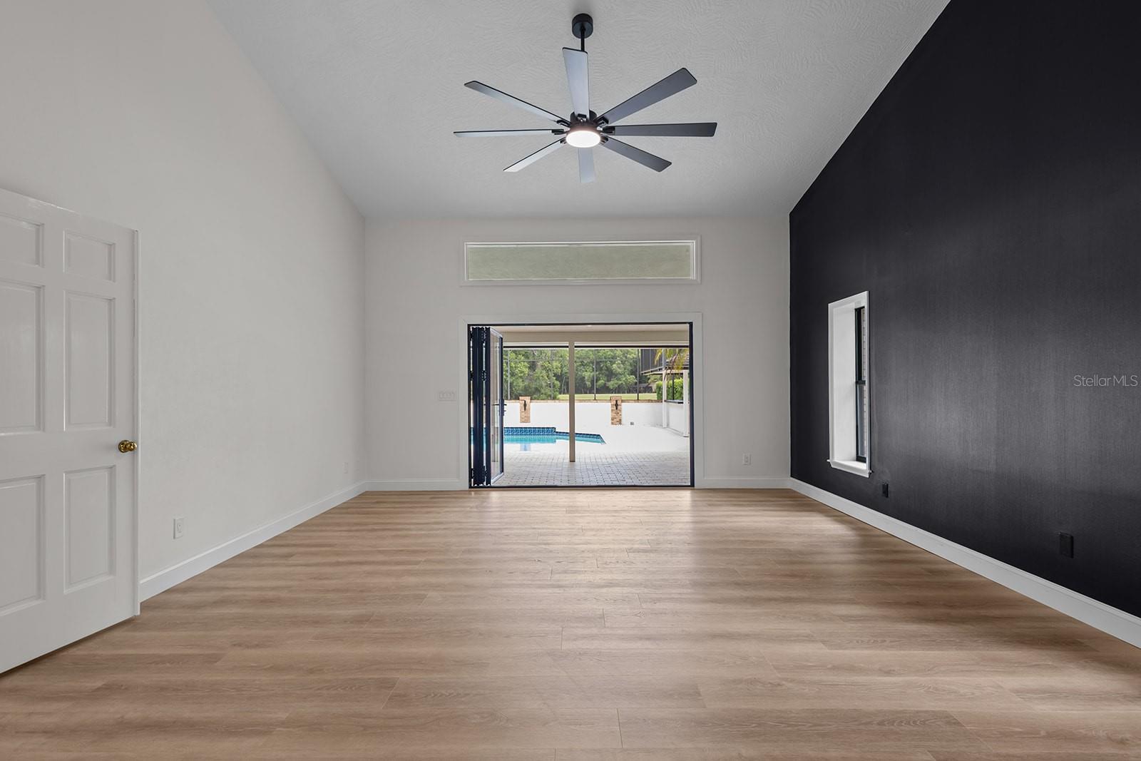 pool view with doors open primary bedroom