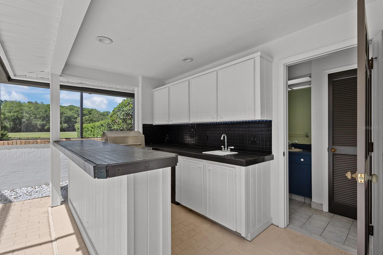 Outdoor covered kitchen with 5th full bathroom