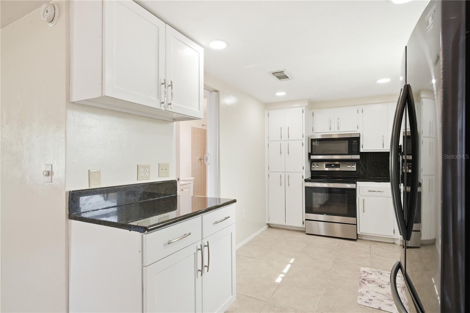 Kitchen with Door to Laundry and Bathroom on the left.