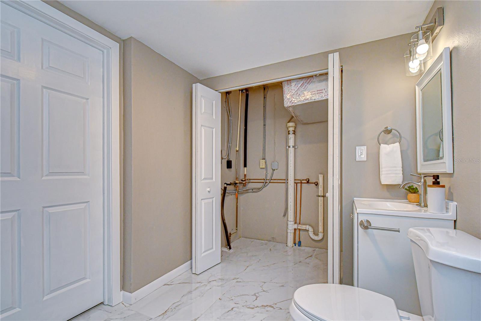 Laundry is located in the guest bathroom