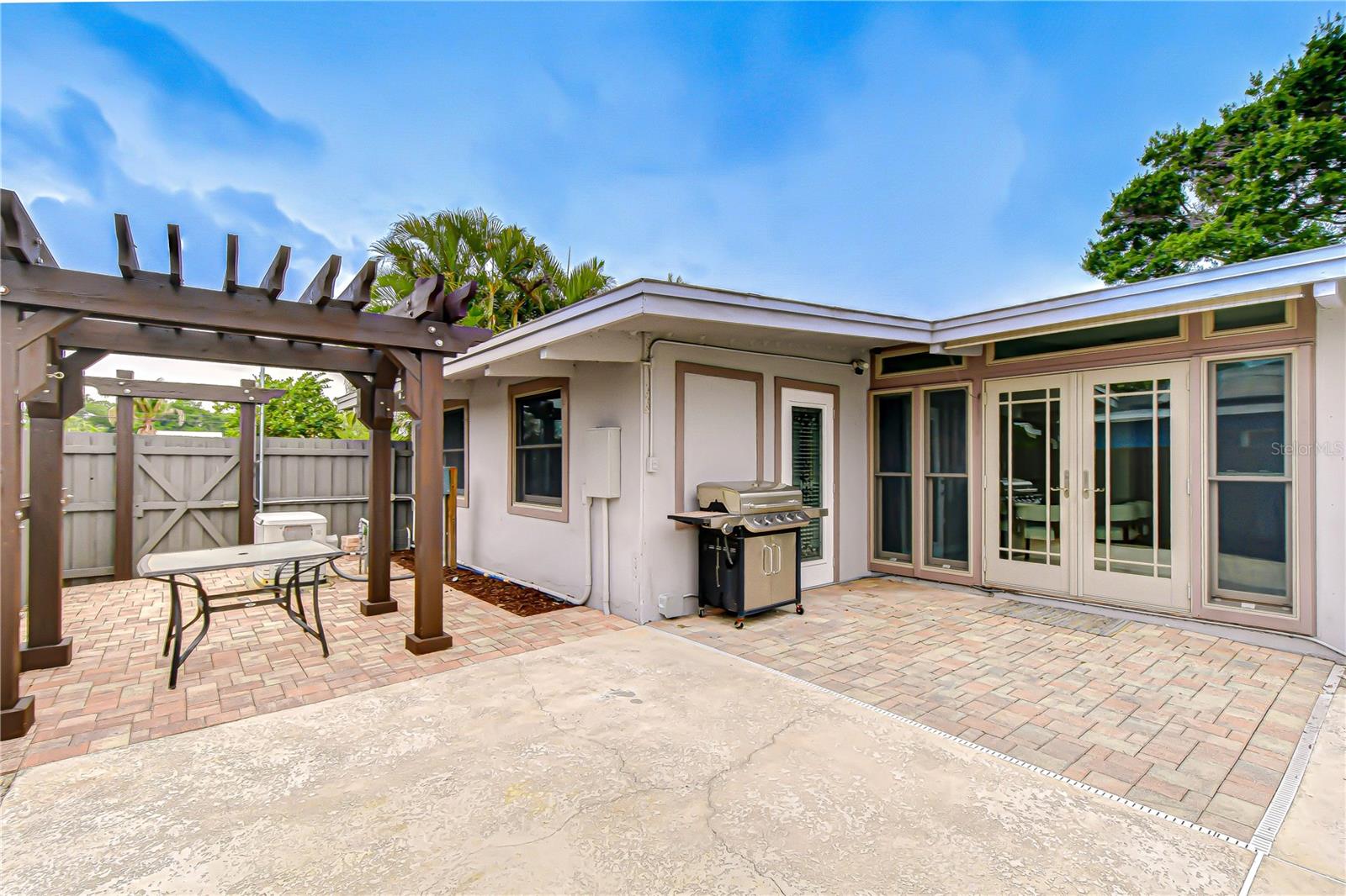 Outdoor pool deck is connected to the side yard via the gate