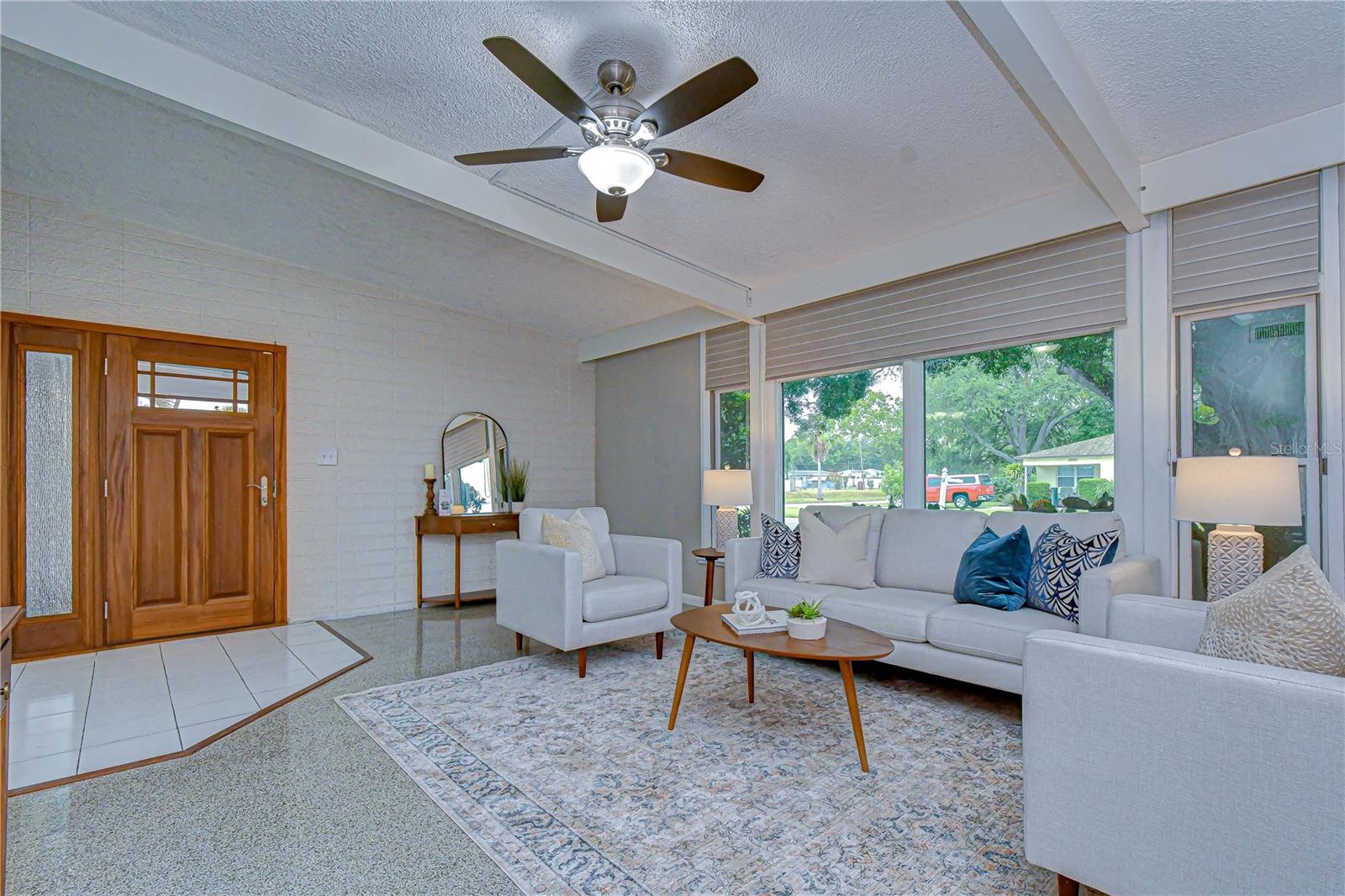 Vaulted ceilings, large windows and wooden beams bring out the MCM aesthetic of this home